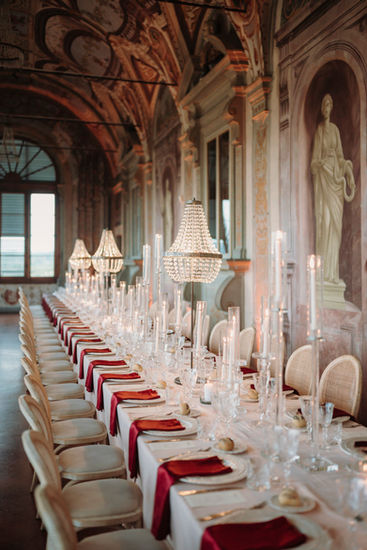 Wedding reception setup in historic hall at Villa Corsini