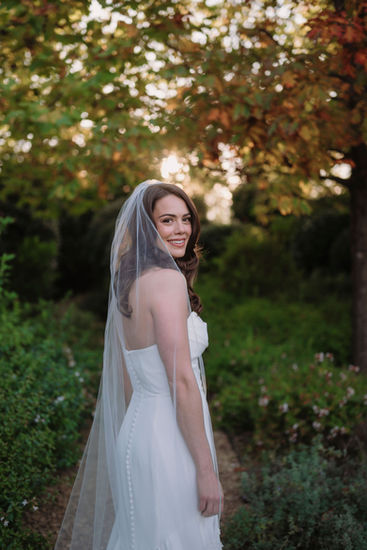 Bride with long veil and soft light in the garden of Borgo Santo Pietro