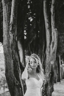 Bride in white dress poses with trees; Alyssa and Sean elopement at riccardopieri