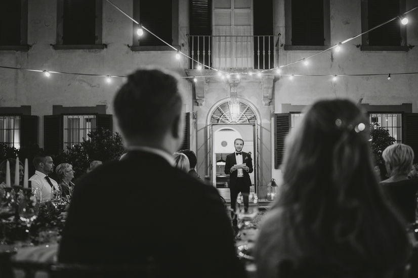 Man giving a speech at a wedding, Alyssa and Sean's elegant elopement at Belmond Villa San Michele Florence.