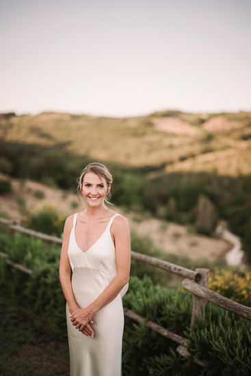 Bride smiles, wearing a white dress, at an Elegant wedding at Conti di San Bonifacio.