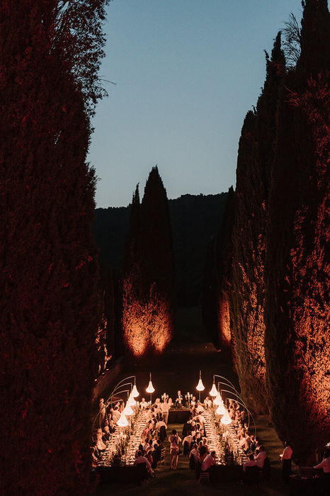 Candlelit wedding detail at night between cypress trees at Villa Cetinale, atmospheric Tuscany wedding