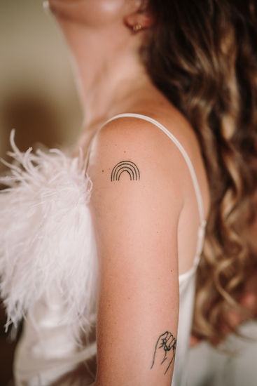 Rainbow tattoo on bride's shoulder