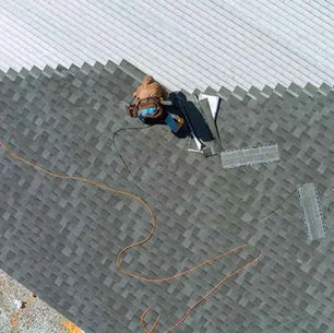 Roofing contractor performing a roof inspection on a residential home in Western PA near Irwin