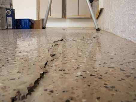 Foundation settlement vs heave comparison showing downward sinking cracks versus upward heave damage in North Huntingdon home