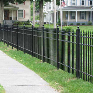 Two neighbors talking across a new privacy fence on a residential property line near Pittsburgh, PA