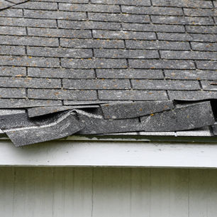 Western PA roof showing winter weather damage with snow and ice buildup illustrating weather roof damage prevention needs