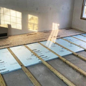 Professional installing closed-cell spray foam to insulate wet basement walls in North Huntingdon PA home