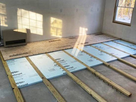 Professional installing closed-cell spray foam to insulate wet basement walls in North Huntingdon PA home