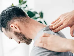 Chiropractor performing a gentle cervical adjustment for neck pain relief at a family chiropractic office in Monroeville PA