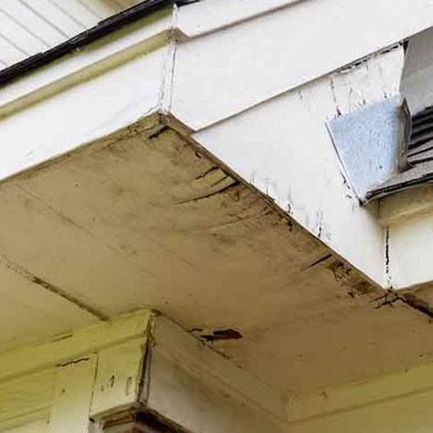Damaged soffit showing peeling paint and holes requiring professional soffit repair in Irwin PA