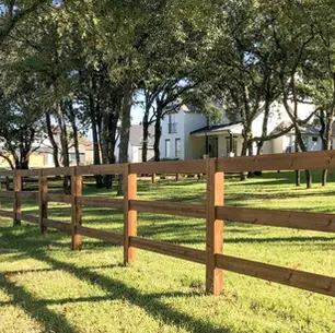 Split rail fence installed on a rural Western PA property with open land and tree line in background