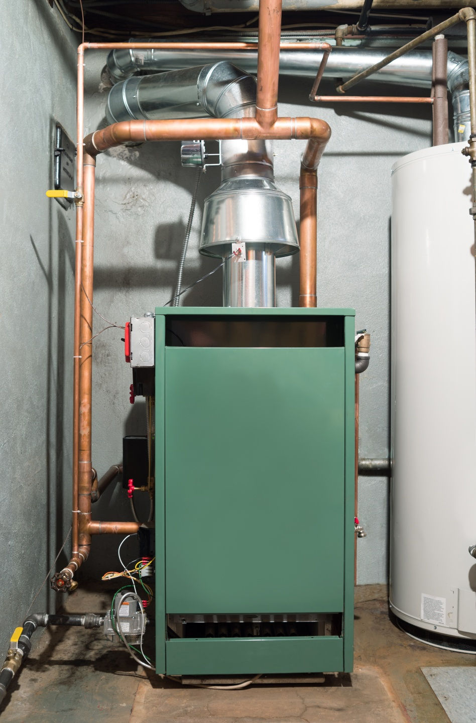 Technician performing furnace repair in a Johnstown PA home during winter heating season