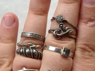 Tarnished silver jewelry pieces showing natural darkening process that affects surface appearance but not underlying value
