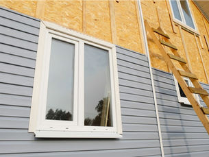 Warped and deteriorating vinyl siding on a Pittsburgh-area home showing signs that replacement is needed