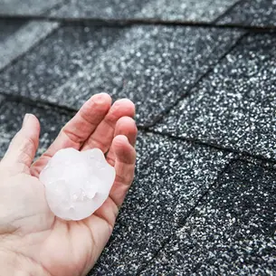 Hail damage on asphalt shingles showing granule loss on a Western PA home roof after a storm