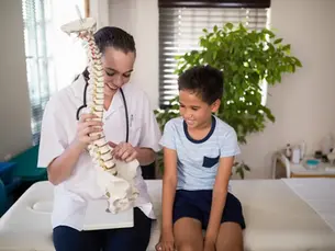 Family chiropractor in Monroeville PA adjusting a young child during a pediatric chiropractic visit