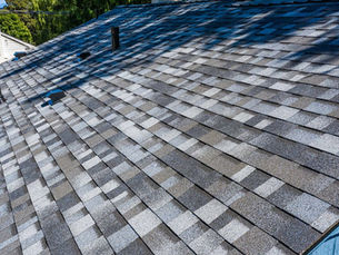 White colonial home with an Owens Corning Pacific Wave blue gray shingle roof in the Pittsburgh area