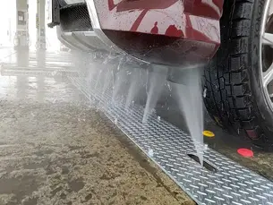 Touch-free undercarriage car wash removing road salt from a vehicle in Western Pennsylvania