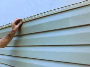 Siding contractors in Bethel Park PA installing new vinyl siding on a Pittsburgh-area home