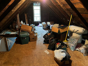 Professional attic cleaning services team removing boxes and furniture from residential attic in Mt. Pleasant PA