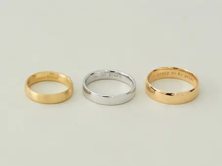 Jeweler engraving a gold wedding band at Brian Nicklaus Jewelry in Greensburg PA