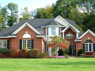 Red brick colonial home with a dark Owens Corning shingle roof in the Pittsburgh area