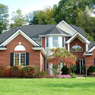 Red brick colonial home with a dark Owens Corning shingle roof in the Pittsburgh area