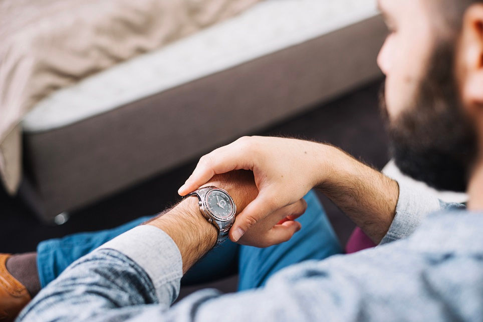 Watch battery replacement service at a pawn shop in Greensburg PA with a staff member inspecting a timepiece