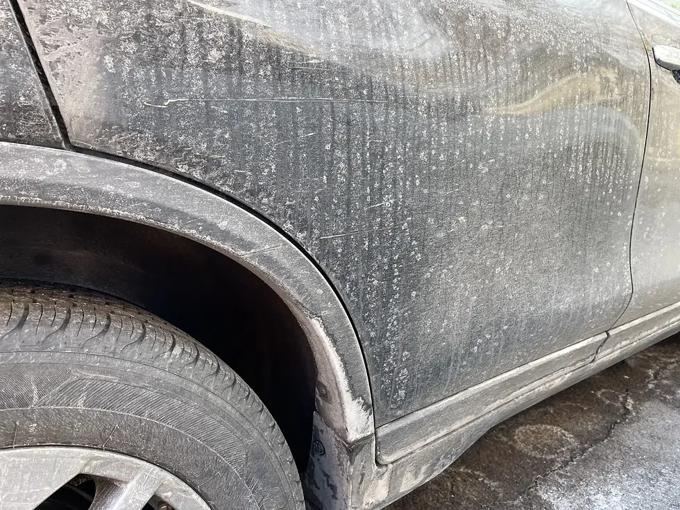 Touch-free car wash removing road salt from vehicle undercarriage in Western Pennsylvania winter