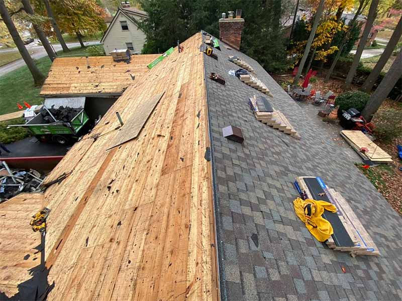 Roofer installing synthetic underlayment and ice-and-water shield on a Pittsburgh home roof replacement