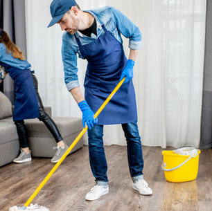 Professional move in cleaning service in Greensburg PA with crew cleaning empty kitchen cabinets and appliances