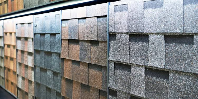 Homeowner comparing shingle color samples for roof replacement in Rostraver Township PA
