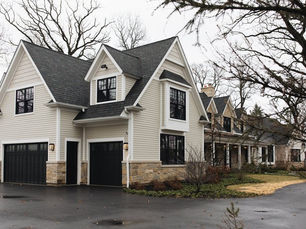 White farmhouse with an Owens Corning Onyx Black shingle roof and black windows near Pittsburgh