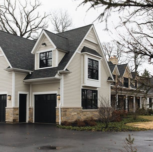 White farmhouse with an Owens Corning Onyx Black shingle roof and black windows near Pittsburgh