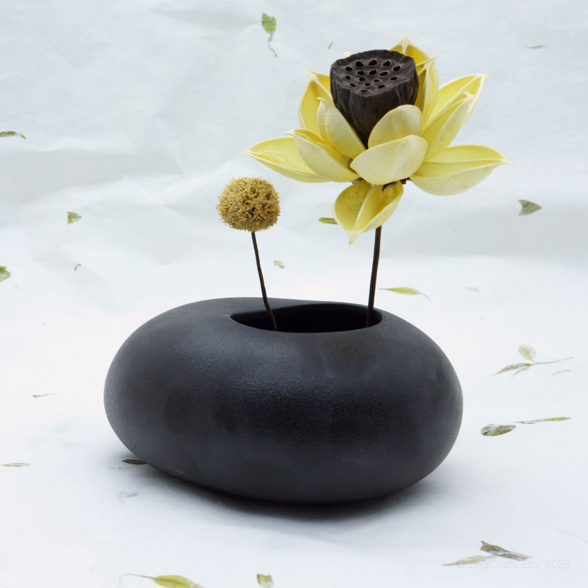 Matt black ceramic vase by EngiCrafts with a minimalist design and asymmetrical opening, ideal for ikebana or decor.