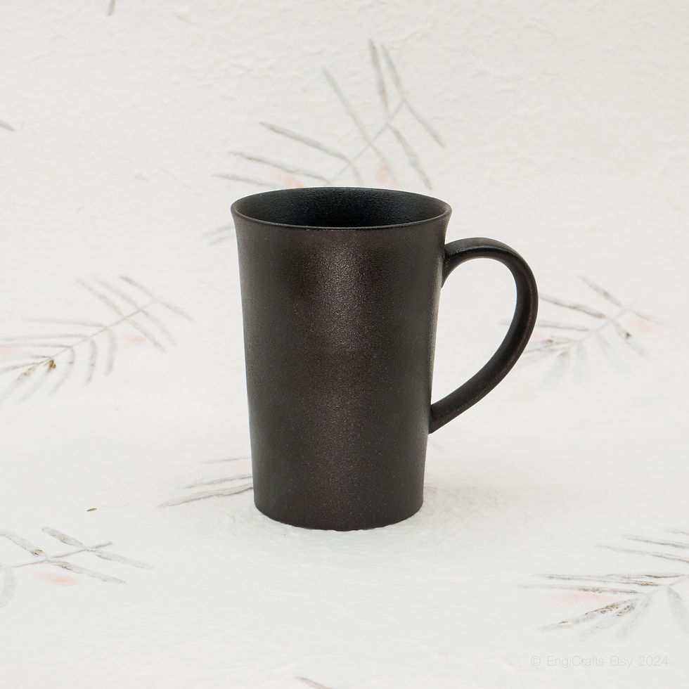 Black ceramic coffee mug by EngiCrafts with a matte finish, sleek shape, and comfy handle, perfect for daily tea or coffee.