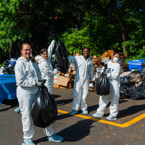 A group of volunteers showing their bags of waste that they sorted through