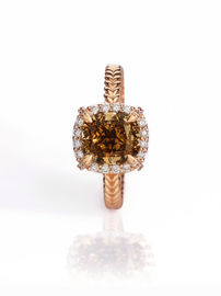 Brown diamond ring with gold band on white background.