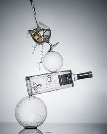 Gyn glass and bottle balancing on top of each other.