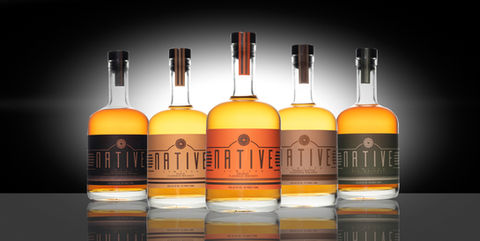 Ecommerce product photography of whiskey bottles on black background for online store.