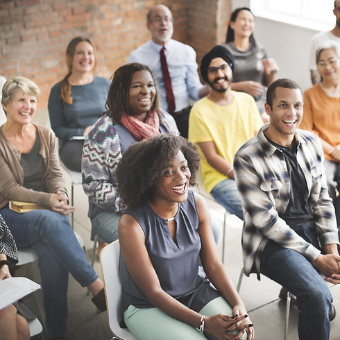 diverse group of smiling adults seated