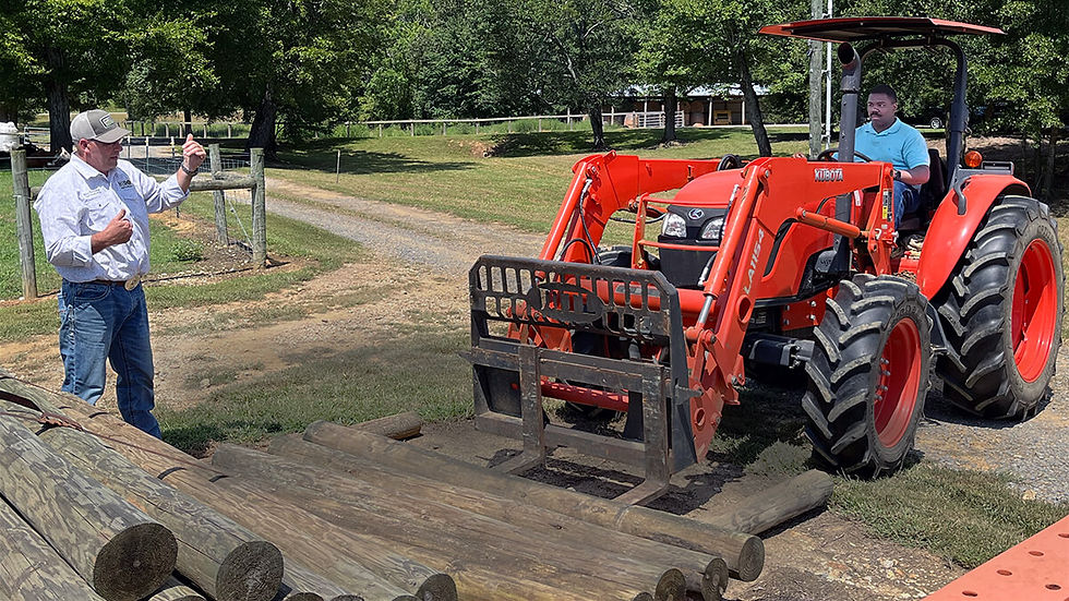 Veterans-using-tractor-to-move-pile-of-fence-posts.jpg