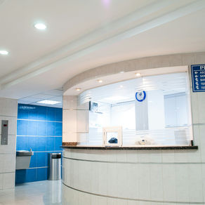 Hospital reception area with a curved desk. 