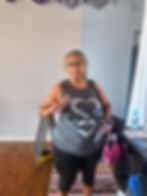 Adrienne Warner throws up one variation of the peace sign after completing Cheryl Davenport’s Rise-n-Flow yoga class at Eastern Sky Co-Op in Bridgeton, NJ, on Saturday, Sept. 20, 2025. (Ahmad Graves-El)