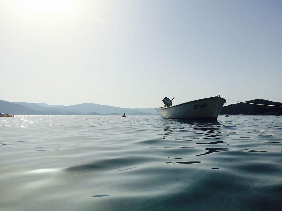 Still waters surround the boat, evoking tranquility and a sense of calmness in the scenery.
