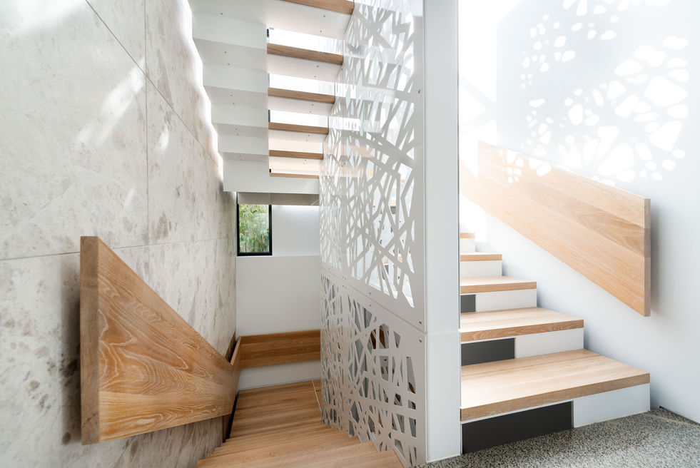 Contemporary staircase with screened enclosure allowing natural light to filter through and illuminate interior spaces