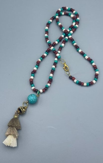 An image of a beaded necklace with a tassel