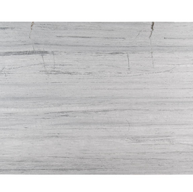 Close-up of Fantasy White Marble featuring a soft white and pale gray background with flowing veins in charcoal and light beige. The polished surface reveals a smooth, elegant pattern with gentle movement and refined contrast.