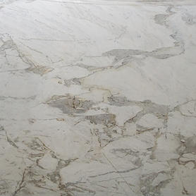Polished Matarazzo Marble slab showcasing a creamy white to light gray background with soft, flowing veining in shades of gray, taupe, and occasional hints of green or gold. The surface has a smooth, high-gloss finish that accentuates the stone’s organic patterns and gentle color variations. Known for its refined elegance and natural beauty, Matarazzo Marble is ideal for high-end interiors including countertops, vanities, backsplashes, and feature walls, adding a sophisticated and timeless touch to both contemporary and classic spaces.